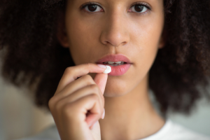 woman taking oral sedation pill