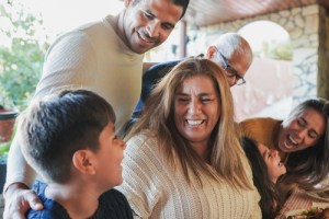 family smiling together at table